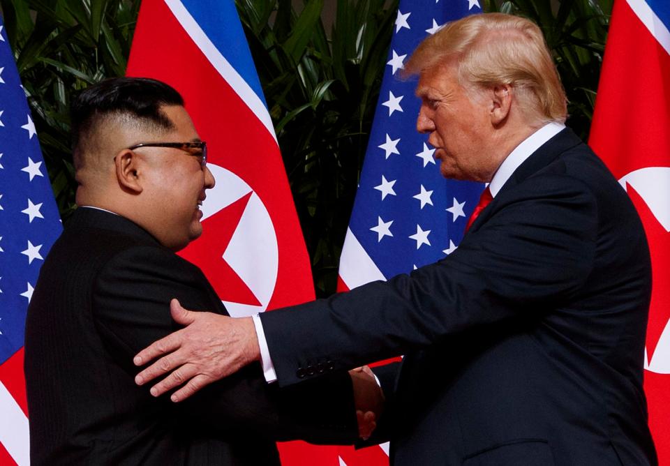  Kim Jong-un and Donald Trump shake hands during their historic summit this year