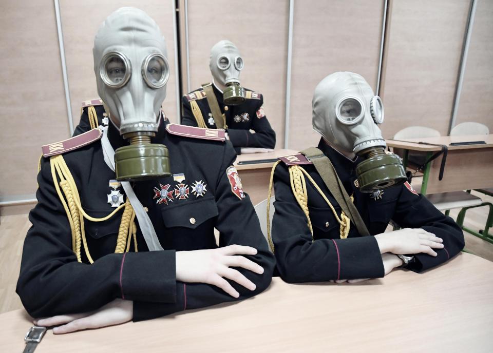  Two young soldiers in Ukraine wear gas masks during a teaching session