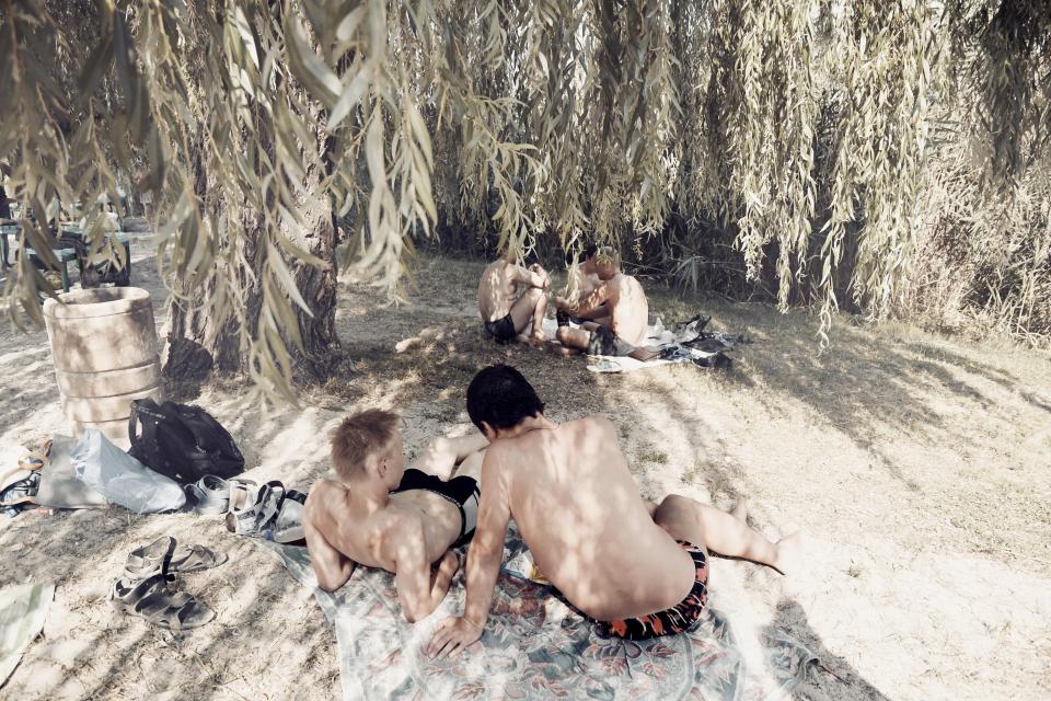  A group of young people hang out by the river in Ukraine