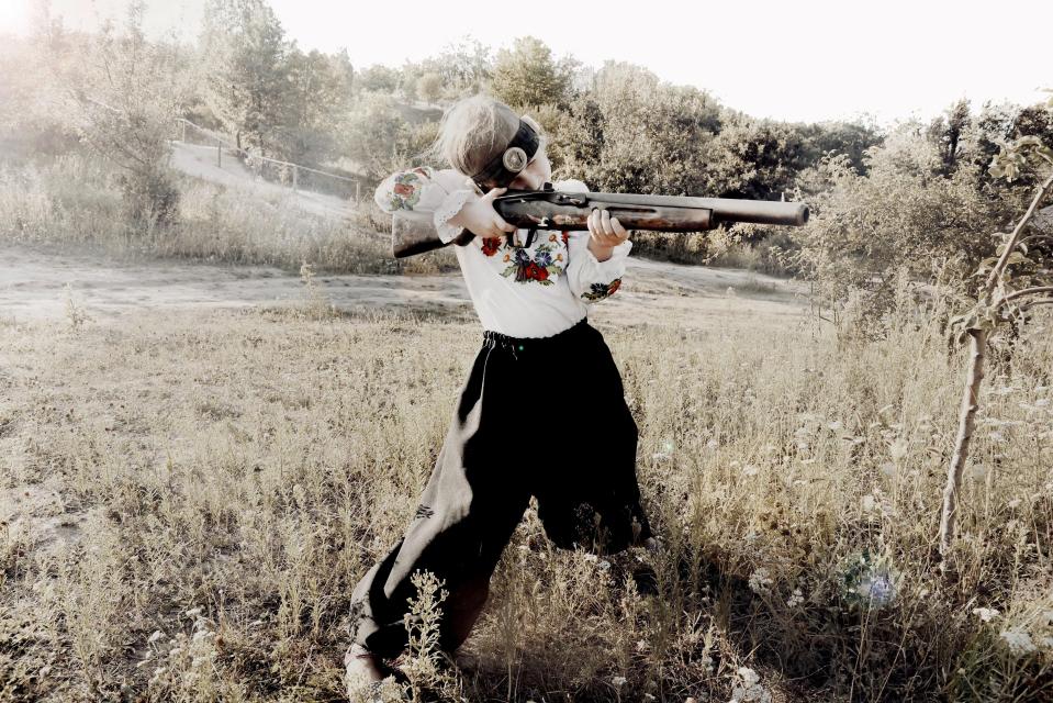  A young girl aims a gun during training at a patriotic camp in Cherkassy