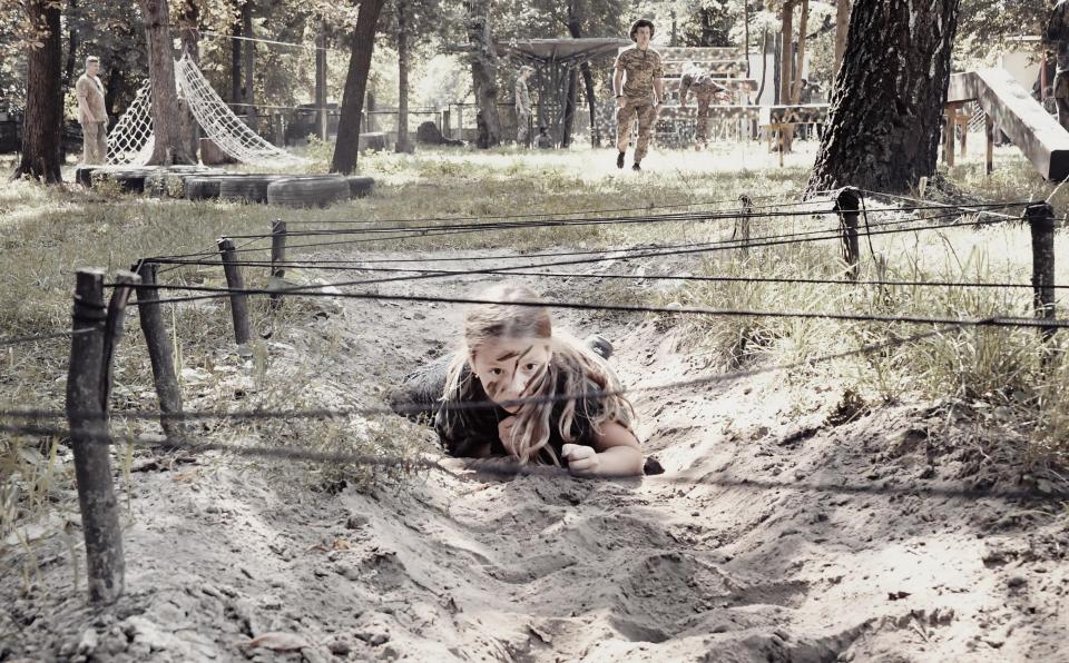  A young girl trains at a military camp