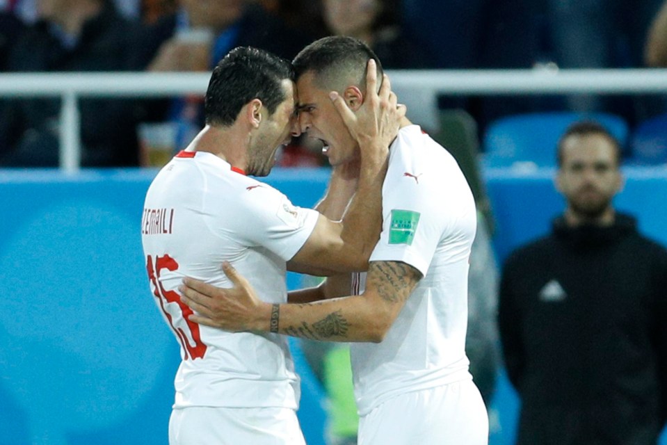 Blerim Dzemaili celebrates with Arsenal midfielder Xhaka