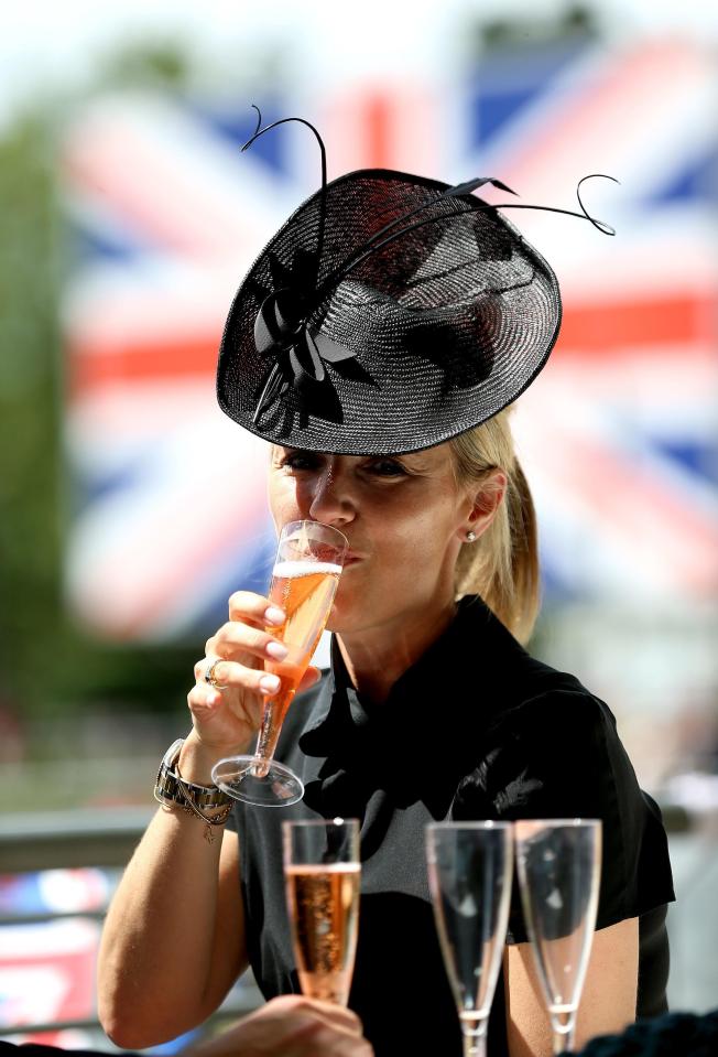  A punter quaffs a glass of fizz during festivities today