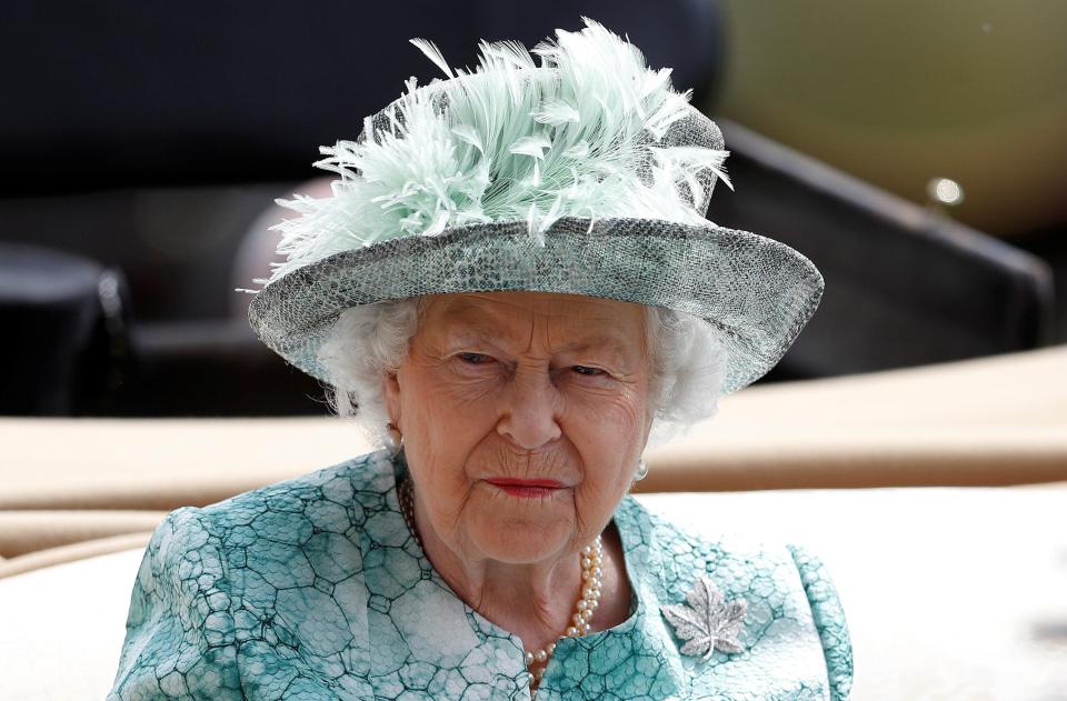  The Queen wore an aquamarine outfit with a feathered hat