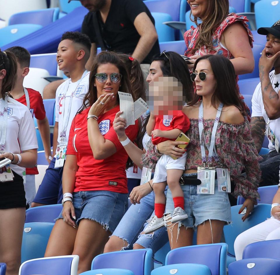  She was pictured next to John Stones' girlfriend Millie Savage and the couple's young daughter