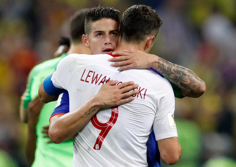  Bayern Munich team-mates Robert Lewandowski and James Rodriguez embrace each other after the match