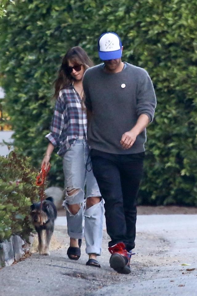  Chris and Dakota looked happy together as they took her dog for a walk