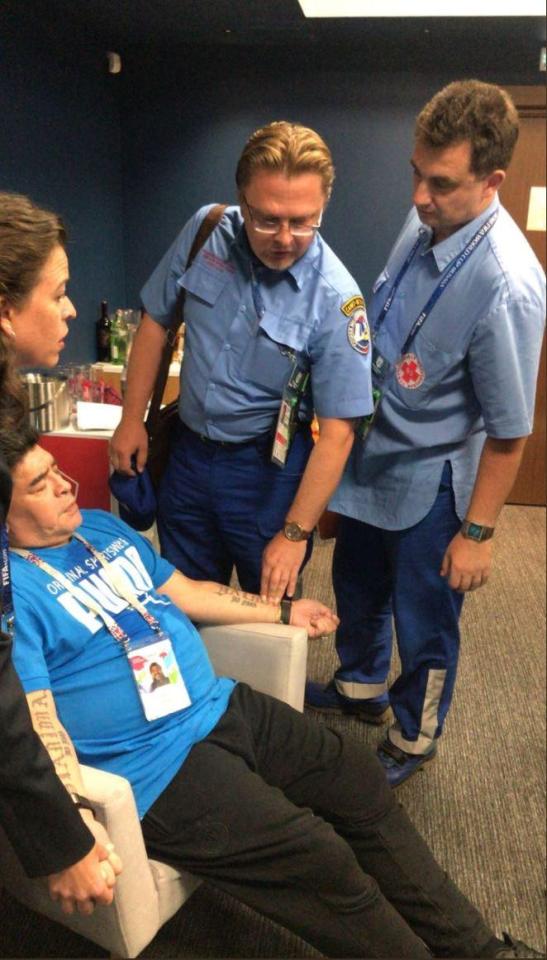  Medics treat Diego Maradona straight after the Argentina win over Nigeria after he fell ill at the end of the game