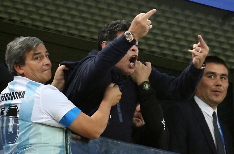 Dieog Maradona was restrained by a colleague as he gave the finger after Argentina hit the winner