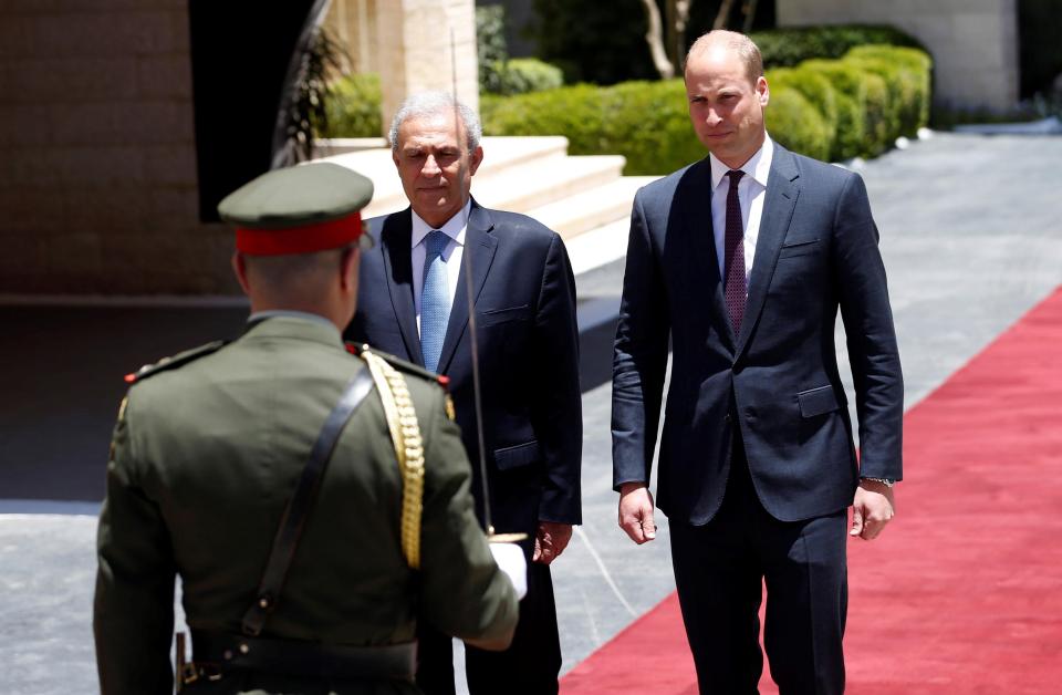  Britain's Prince William reviews the honor guard during a reception ceremony in the Israeli-occupied West Bank