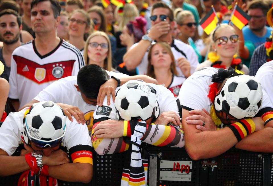  Germany fans hang their heads after watching the World Cup dream end in humiliation