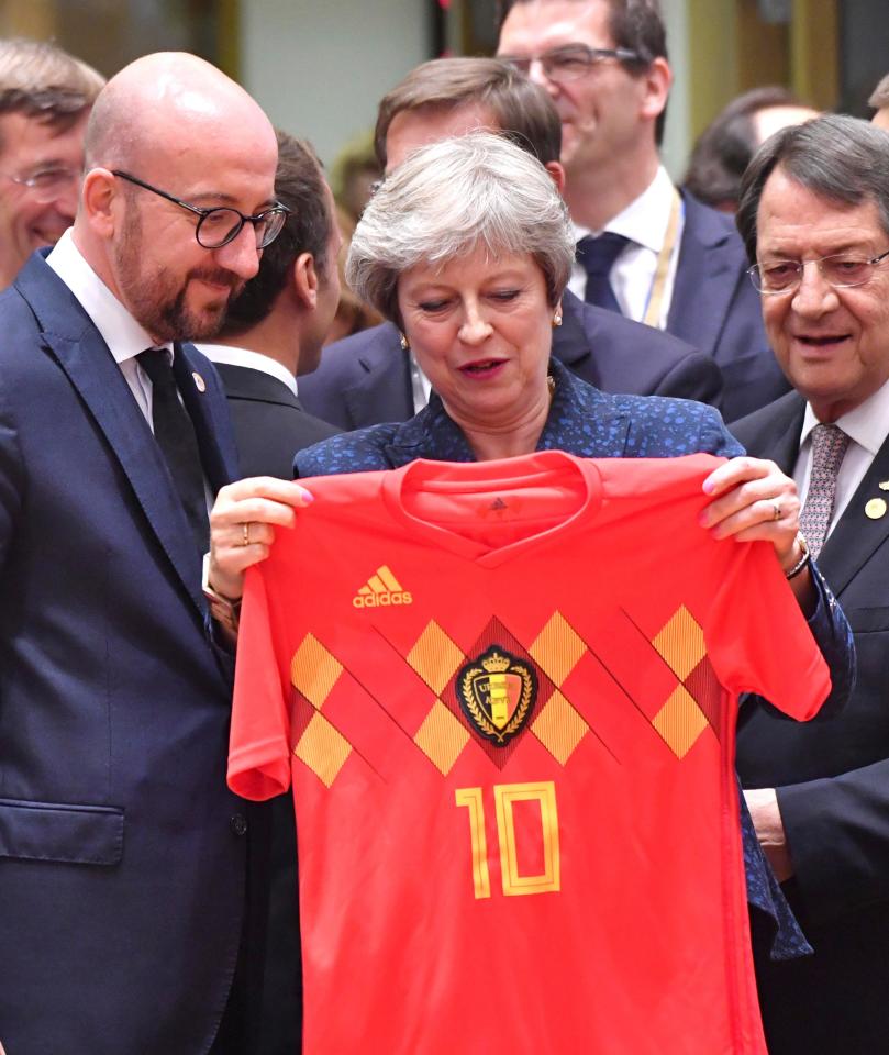 Theresa May has been presented with a Belgium shirt by the country's Prime Minister Charles Michel