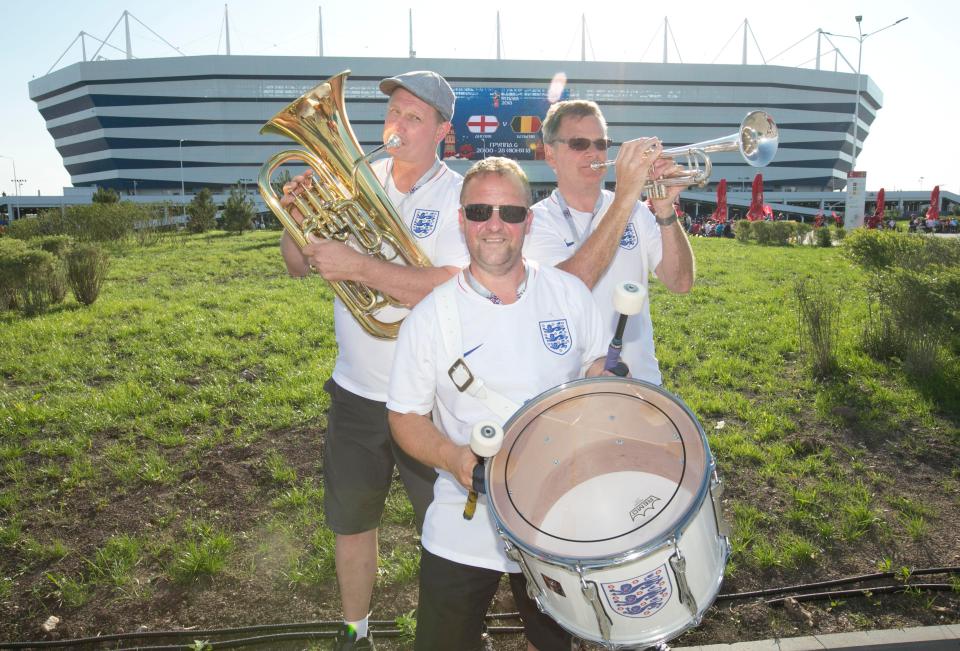 The England band tune up their trumpets outside the ground