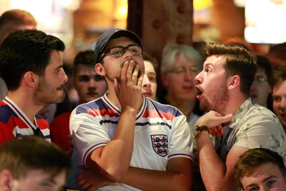 England supporters look anxious after Belgium take a second-half lead