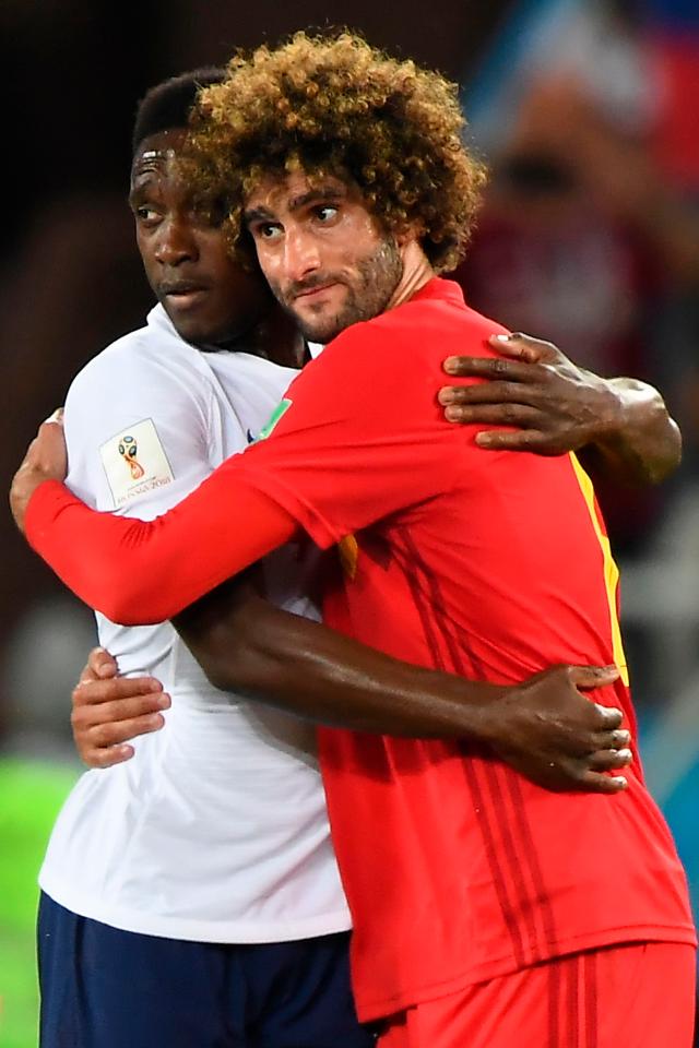 Danny Welbeck and Marouane Fellaini exchange hugs after the Group G clash