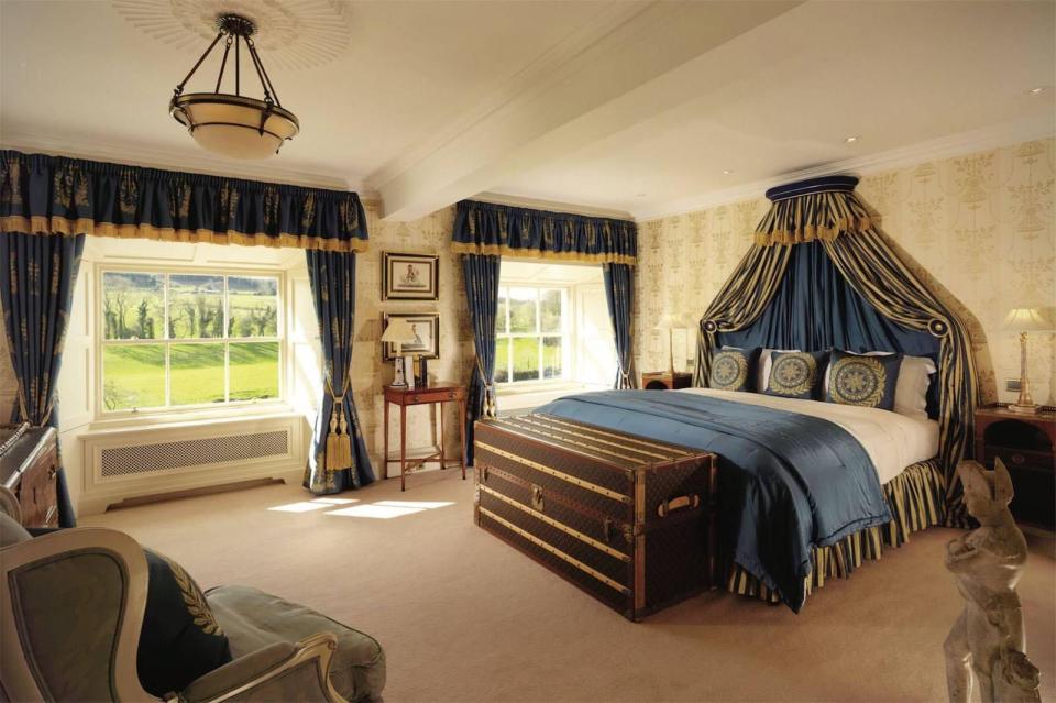  An antique trunk sits at the end of this double bed