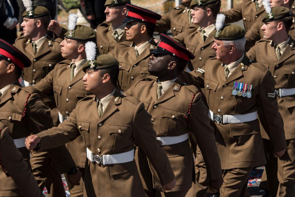 Military personnel parade past Britain's Princess Anne in Llandudno