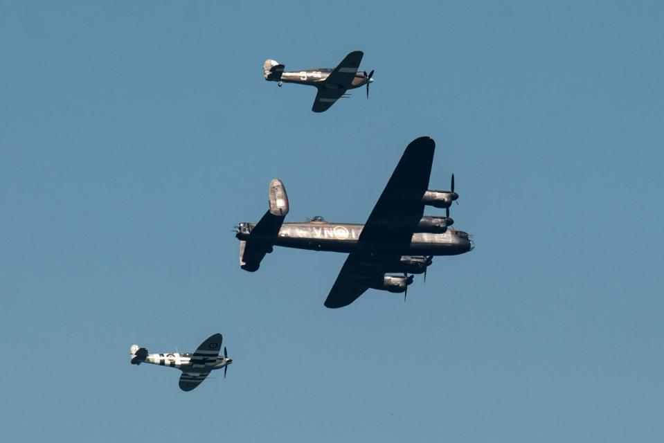 A Spitfire, Hurricane and a Lancaster Bomber perform an aerobatic display