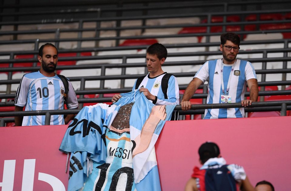  An Argentina fan pulls up the Lionel Messi shirt he displayed during France defeat