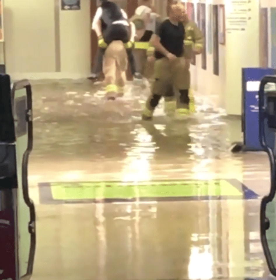  Firefighters carrying drenched commuters out of Didcot railway station