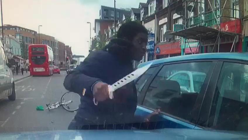  A cyclist armed himself with a huge knife in the 'road rage' row in Croydon, battering the car door