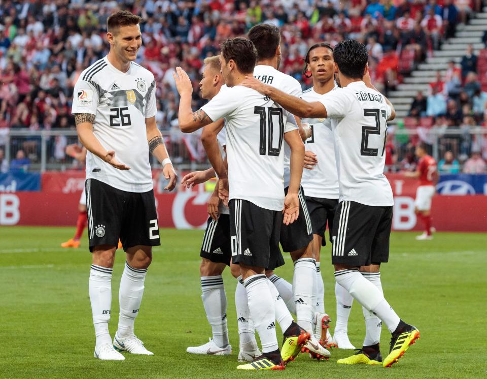  Mesut Ozil celebrates with his team-mates after the early opener