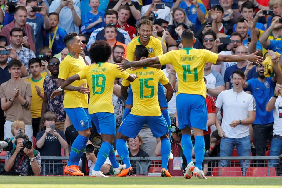  Neymar is mobbed by his team-mates after netting in front of the Kop