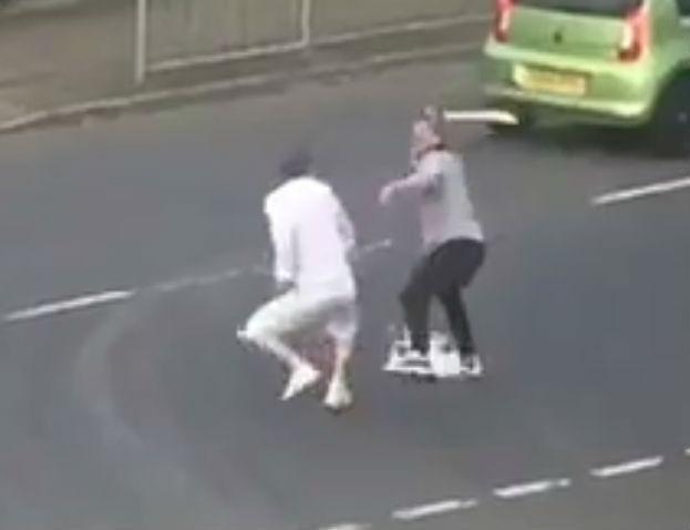  A sword-wielding thug chases a man down a street in Glasgow in shocking footage