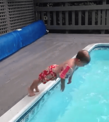  The little boy hits the water with a smack