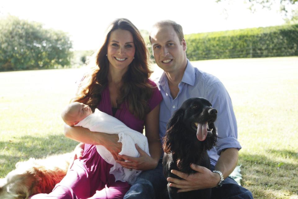  Prince George cradled by his mother in the Middleton family home garden in August 2013