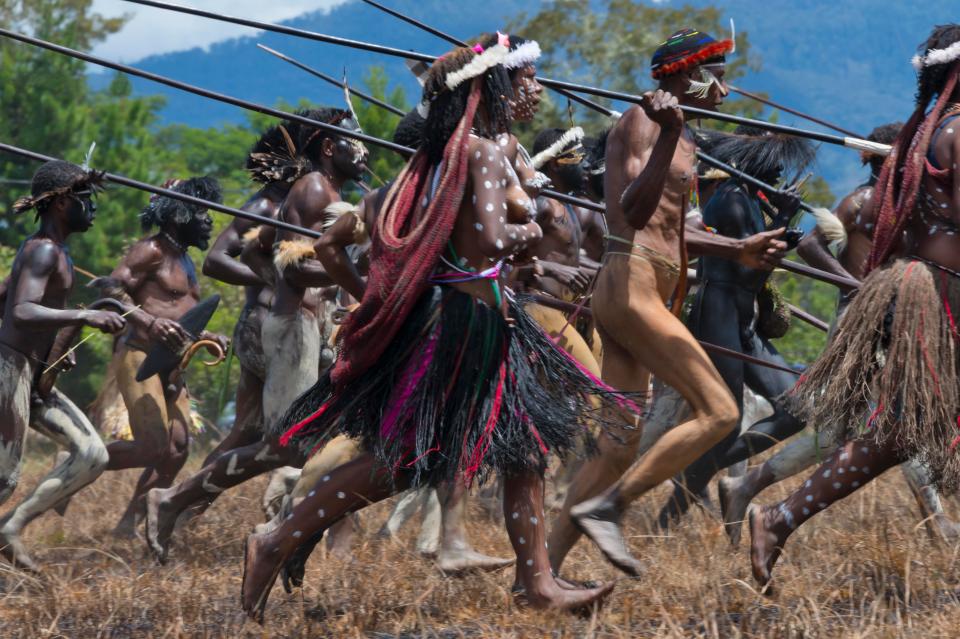  Dani men and women holding spears at Baliem Valley Festival