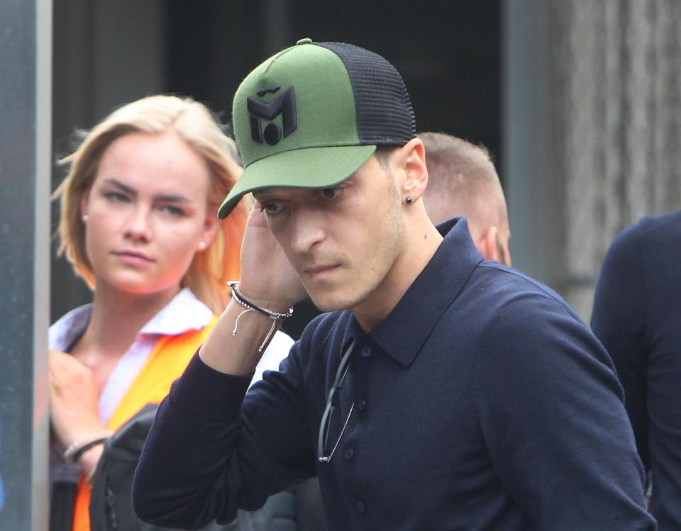  Ozil and Germany were back at Frankfurt airport on Thursday after their early exit