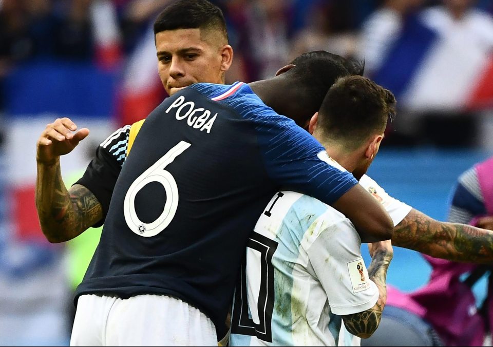  Pogba towers over Messi and puts an arm around him after sending Argentina home from the World Cup