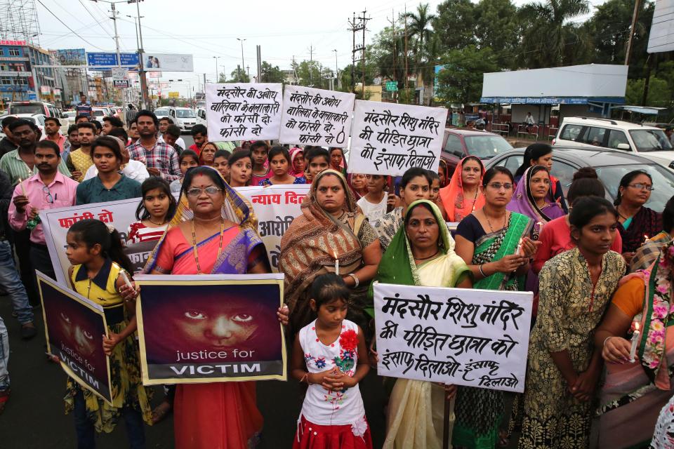  Protesters hold posters and candles during march against the rape of a seven-year-old girl in Mandsaur, in Bhopal, India