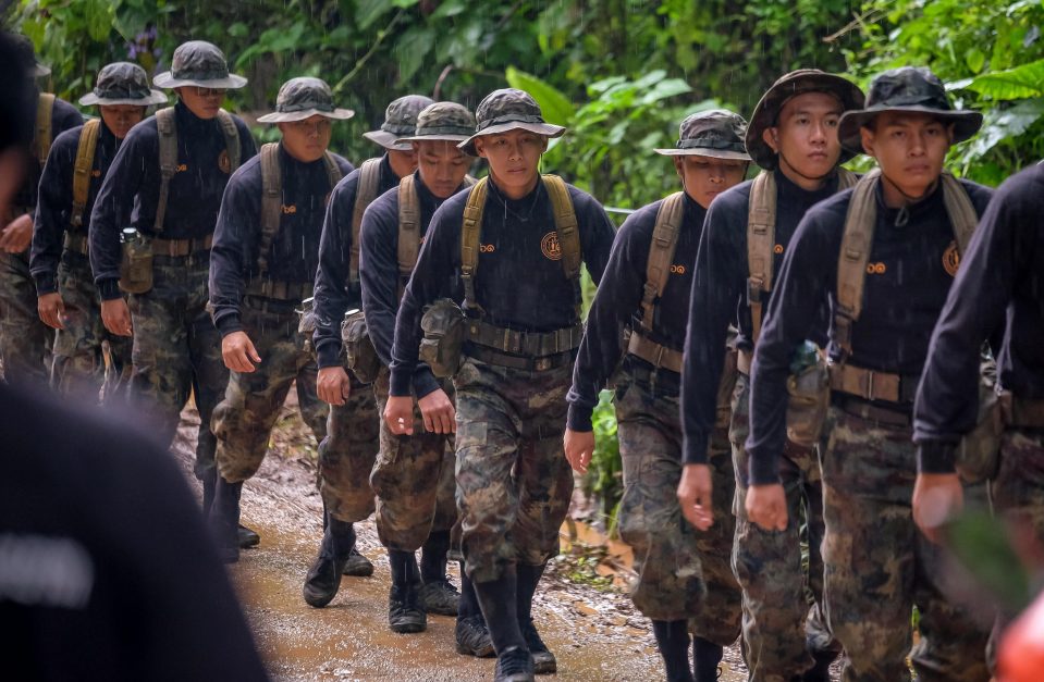  Members of the Thai military march into the entrance of the cave