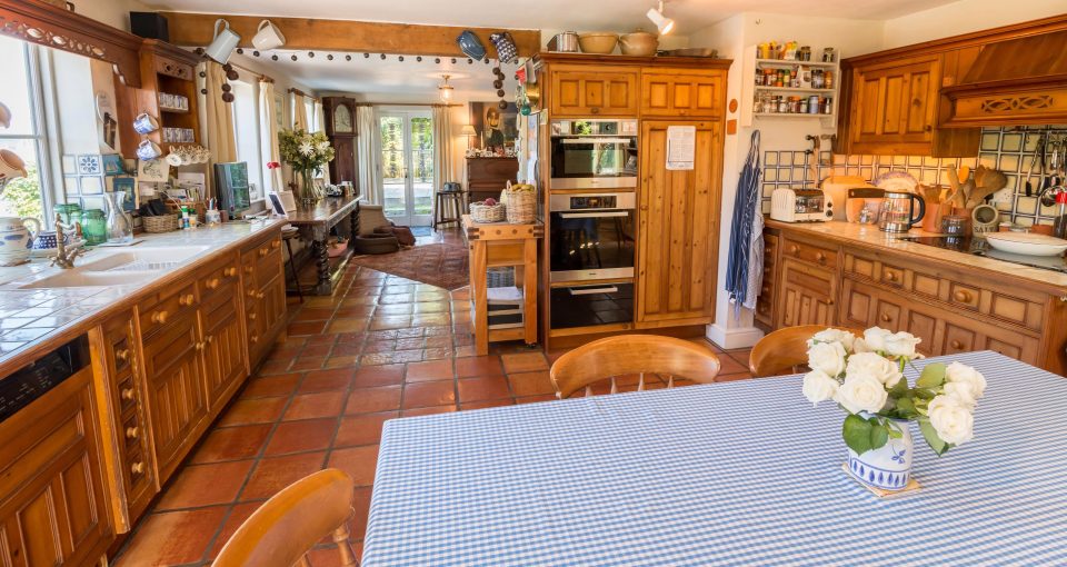  The large kitchen-dining room spans the width of the house