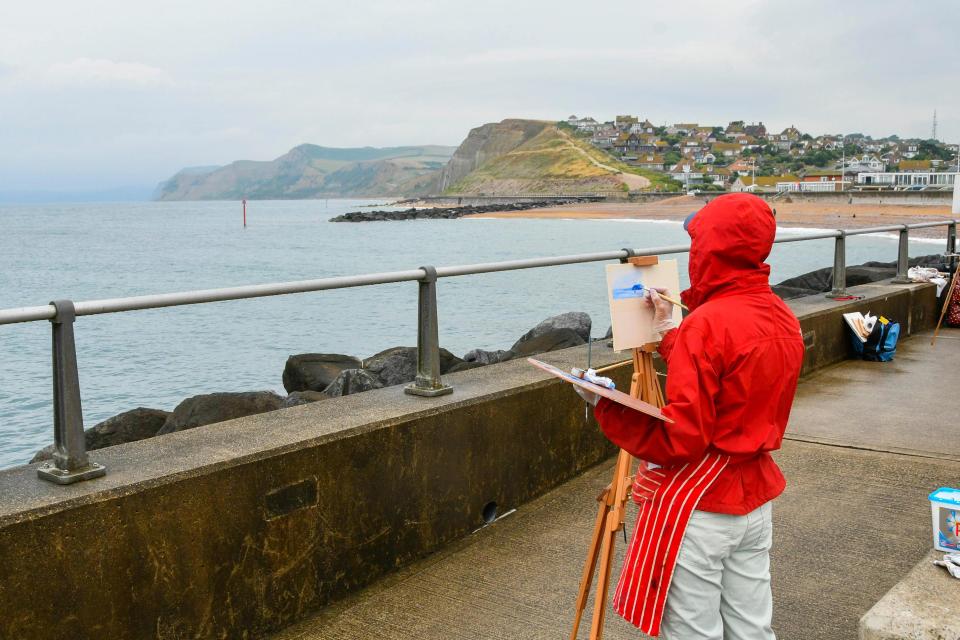  An artist captures the stormy scene in West Bay, Dorset today