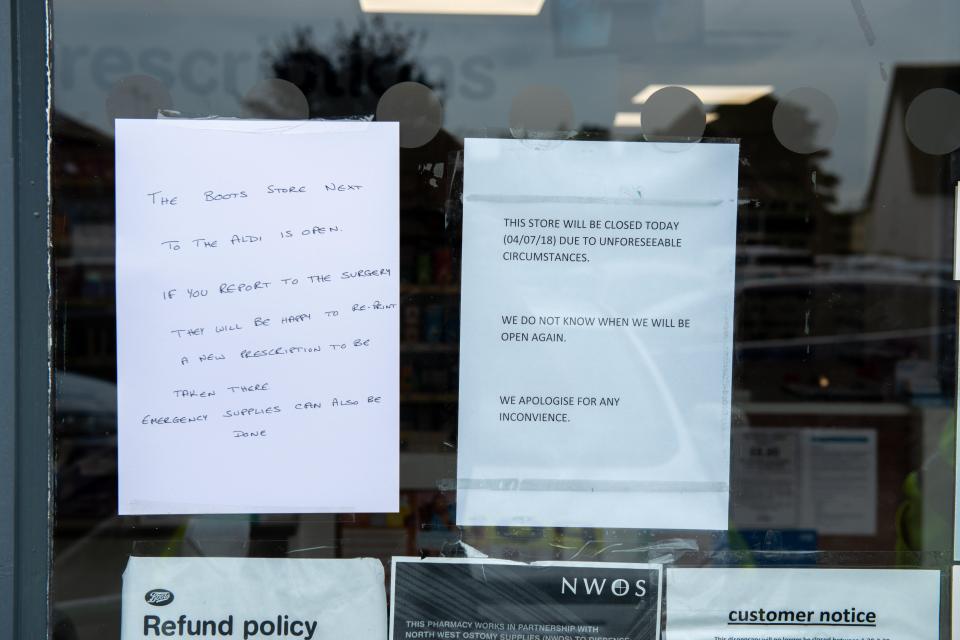  A notice in the window of the store reads 'we do not know when we will be open again'