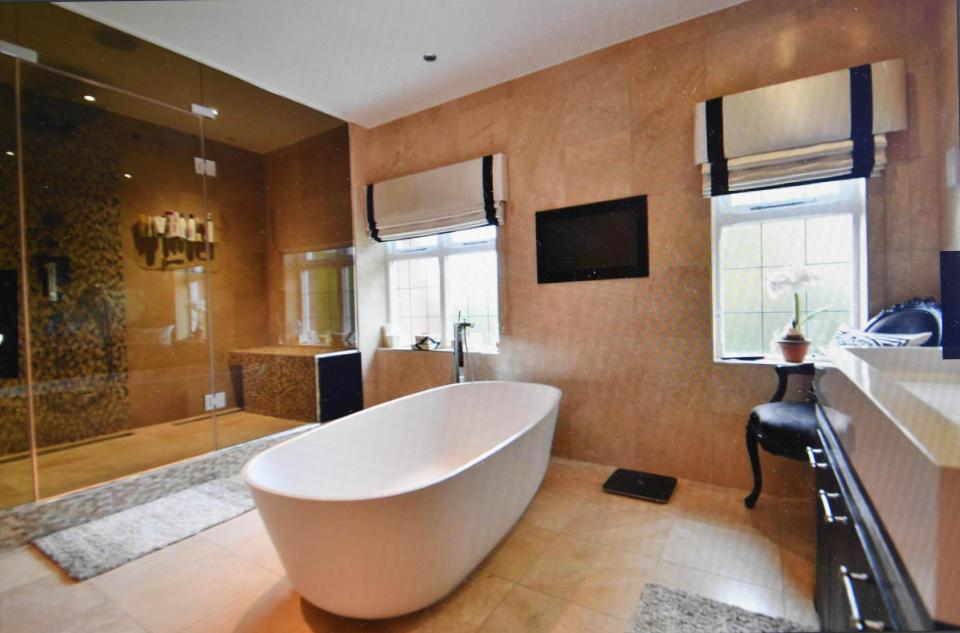  The £1.9m home has four stunning bath/shower rooms