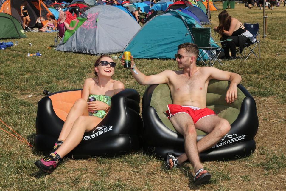  These party-goers crack open the drinks to cool off in the blazing sunshine in Somerset