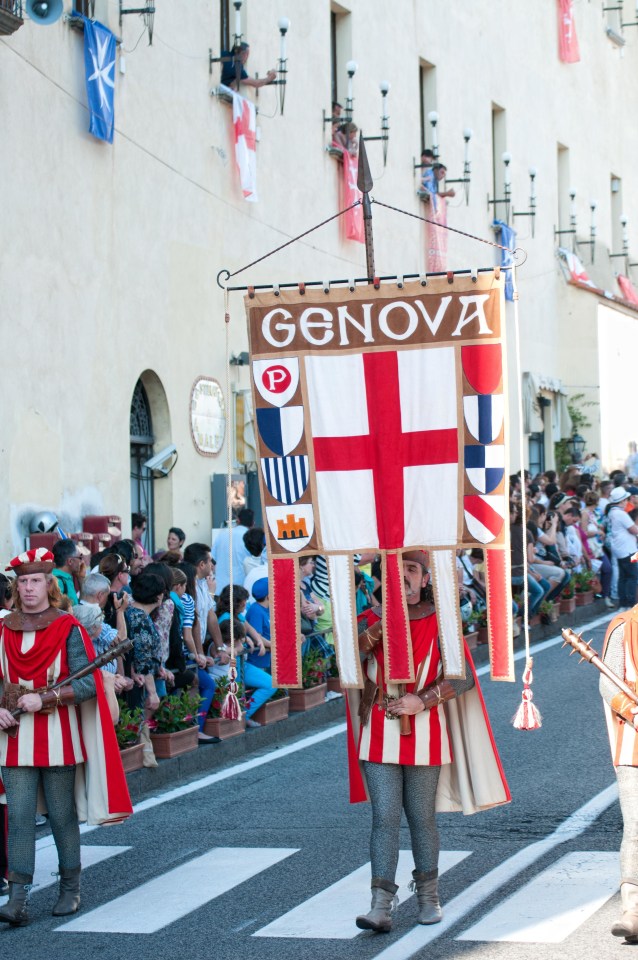 The St George's Cross is carried through the streets of Genoa in a parade