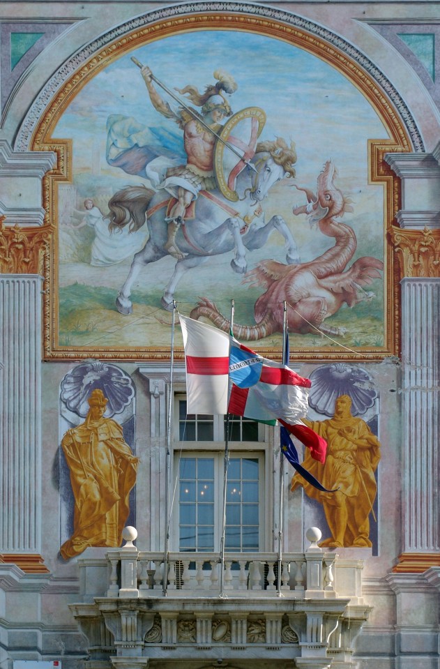 The flag flies in front of an image of St George on Genoas San Giorgio palace