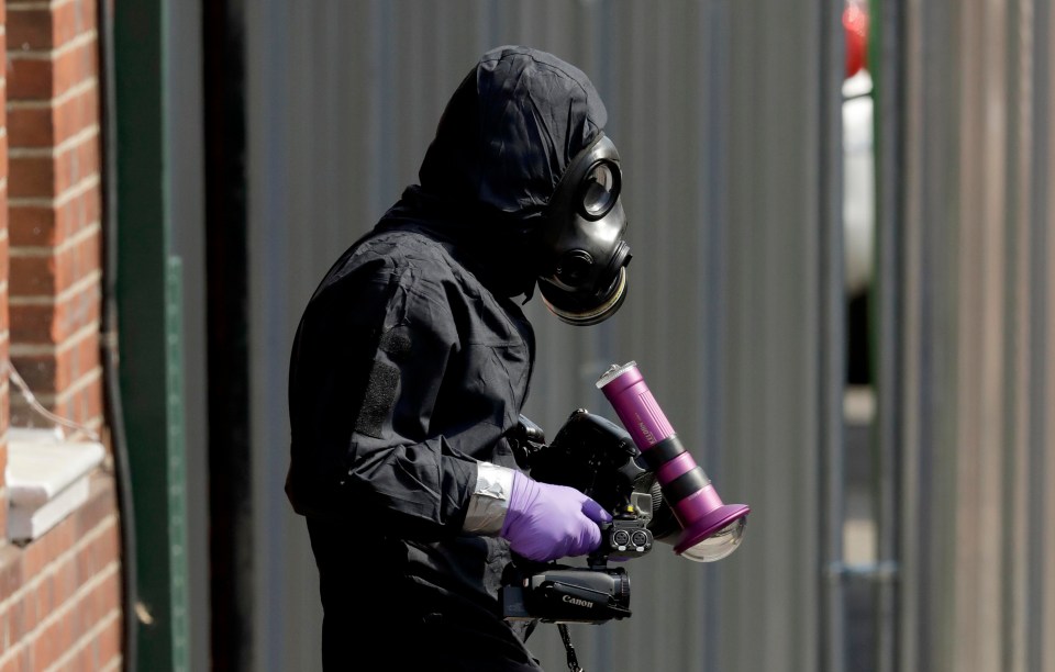 A specialist team member leaves the homeless hostel as British police continue to scour Salisbury and Amesbury for traces of Novichok