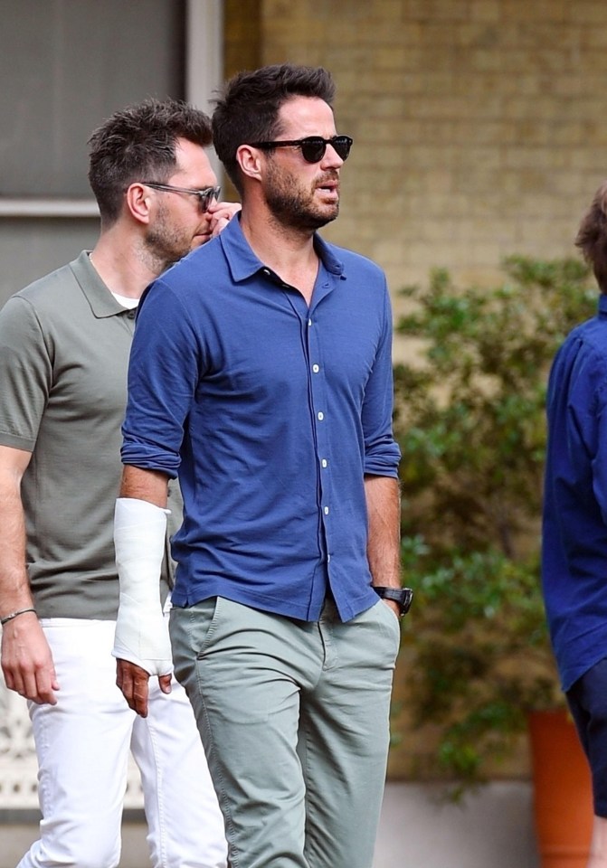 He looked effortlessly cool in a blue polo shirt and grey trousers