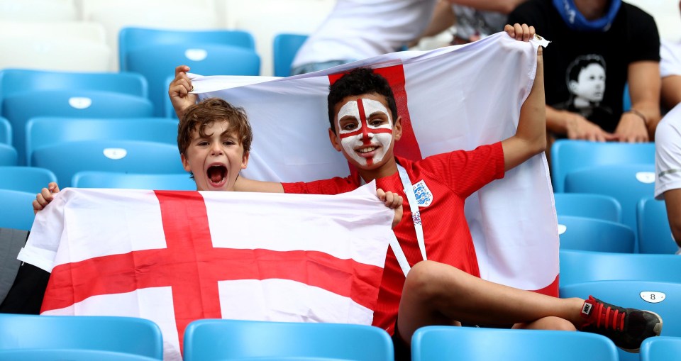 Two young fans hoist England fans in the Samara Arena