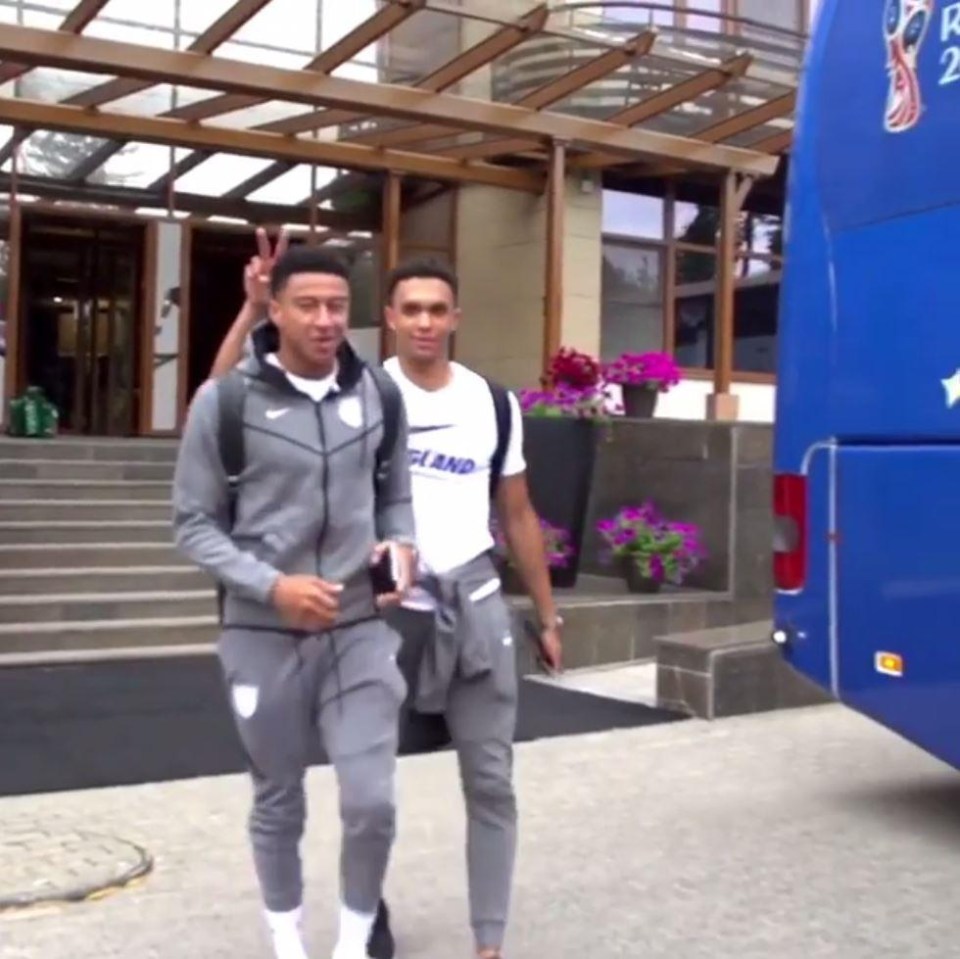 As the two England stars walked out of the hotel, Trent Alexander-Arnold put up two fingers behind Jesse Lingard's head