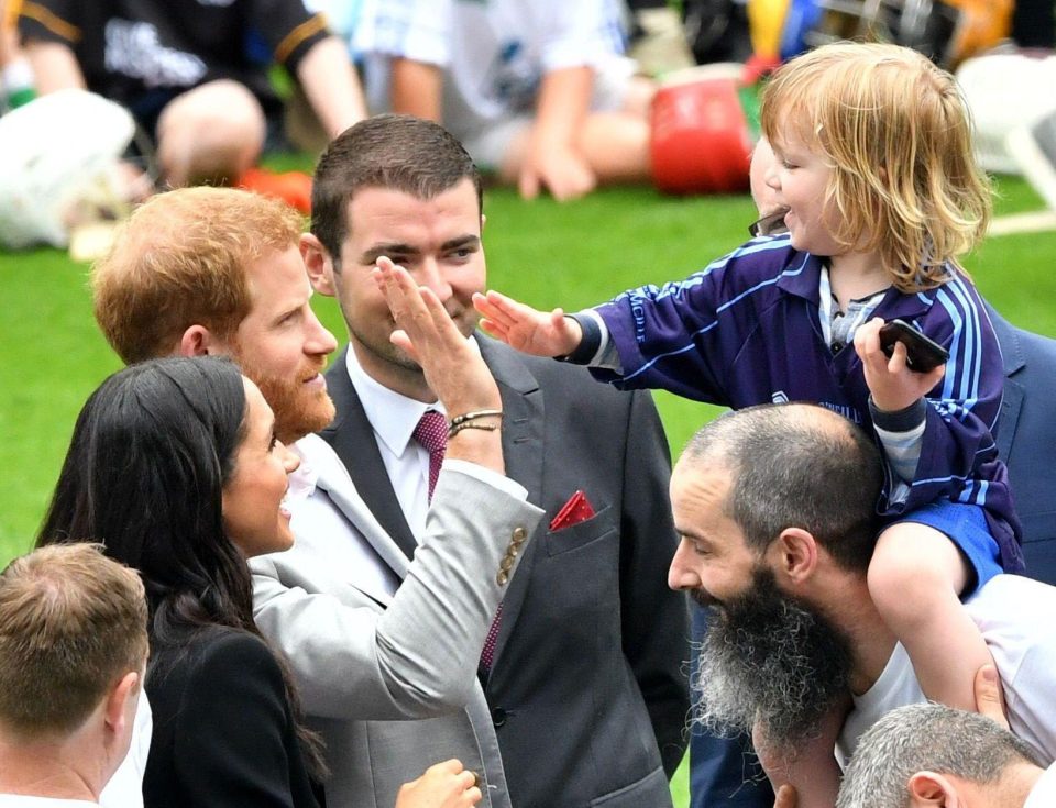  After winning Harry and Meghan over the tot went for a high five with the Prince