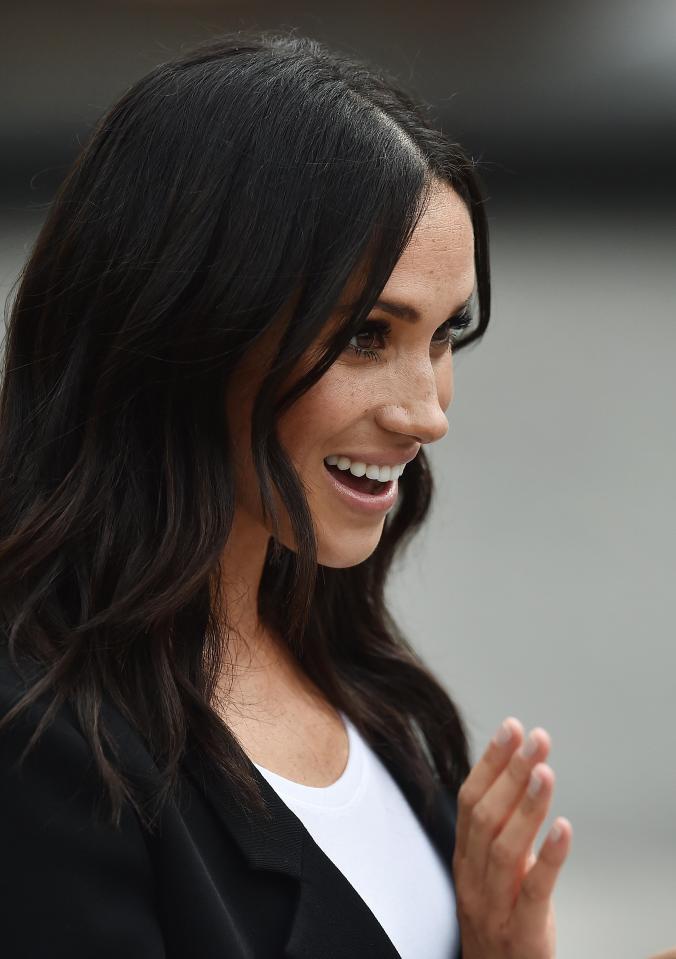  Meghan was pictured smiling as she watched dozens of kids playing gaelic football and hurling