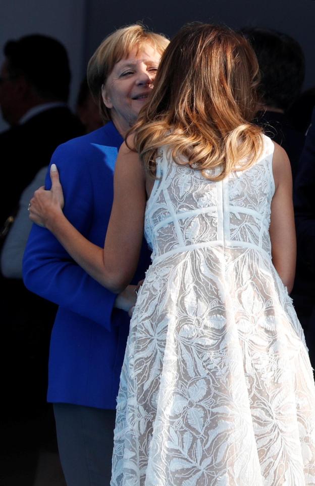  The First Lady was seen giving Mrs Merkel a kiss on the cheek during the party