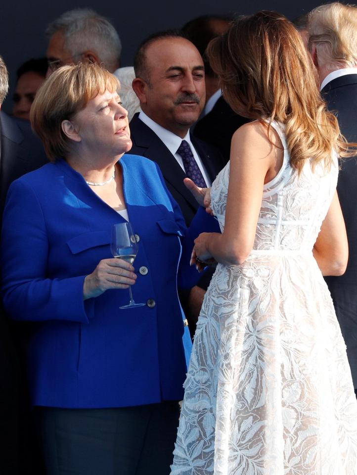  Melania speaks at length with Angela Merkel during a  Nato cocktail party on Wednesday evening